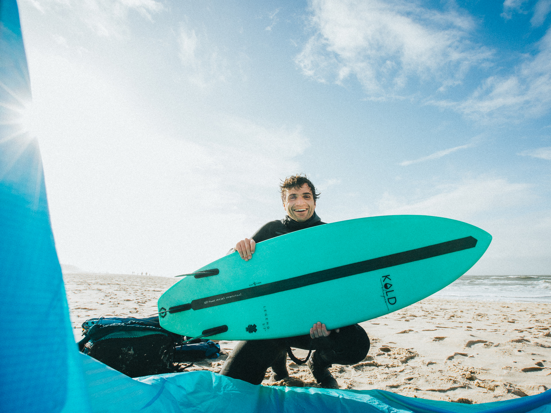 Photographer with kitesurf wave board on the beach of Sylt, Germany, passionate kitesurfer